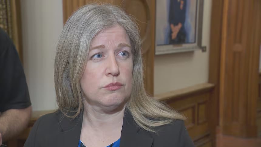 A blond woman looks off to the right.