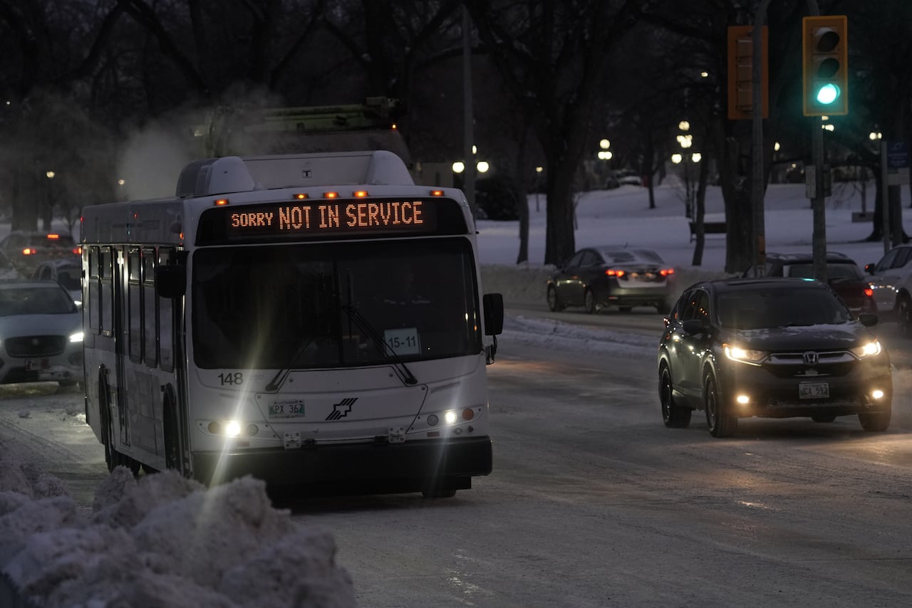 A bus with a display that says 'sorry NOT IN SERVICE' on a snowy street.