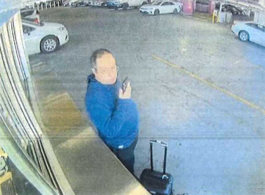 Neves Valente stands at a car rental window in Boston.