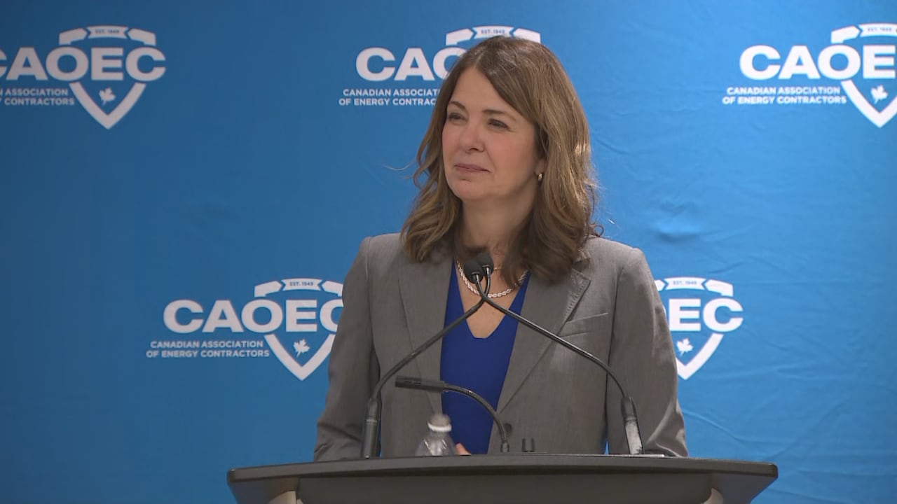 A woman stands behind a podium.