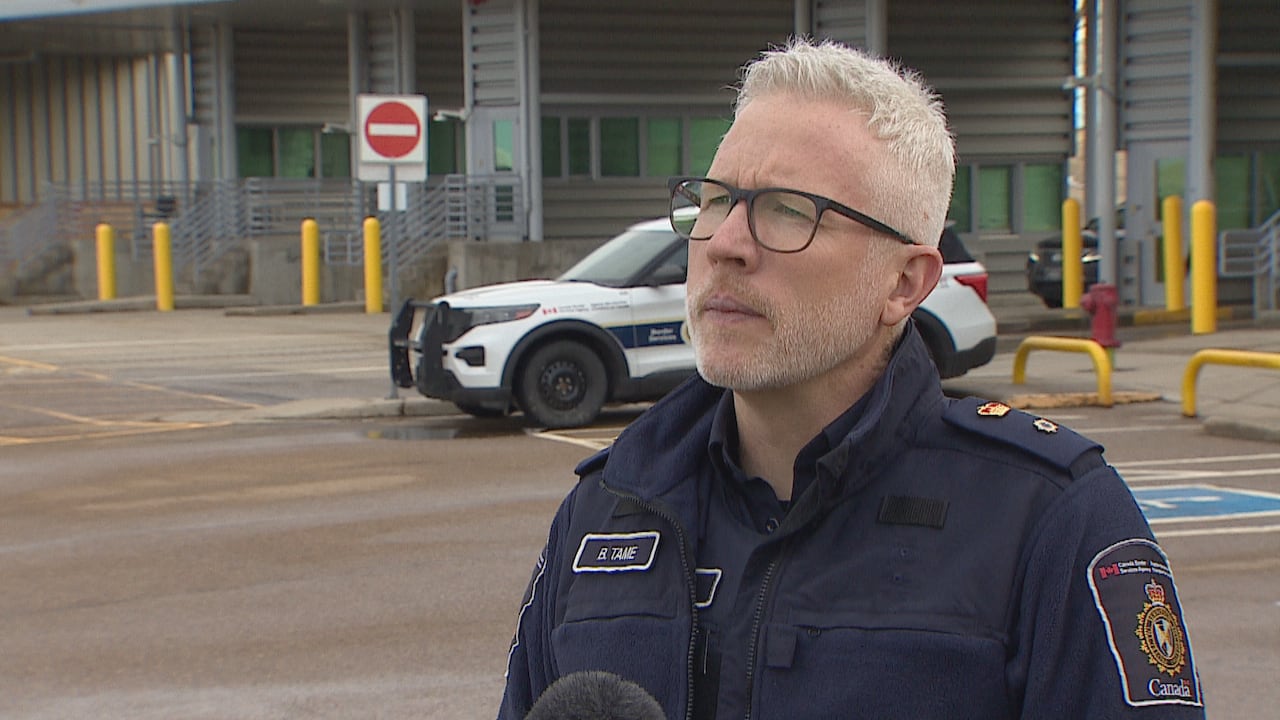 An officer stands in a parking lot.