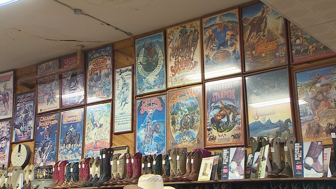 A wall full of boots and posters is pictured.