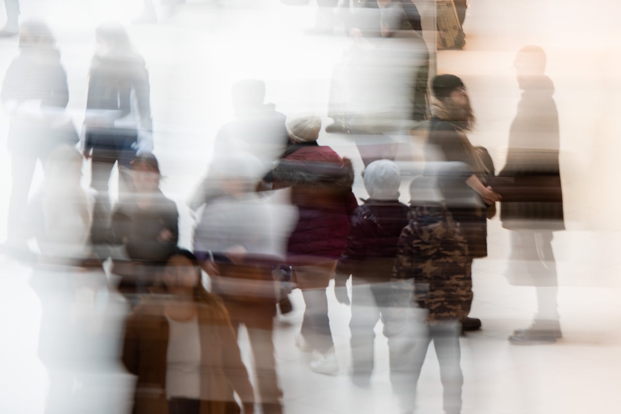 People move through a mall on a busy shopping day.