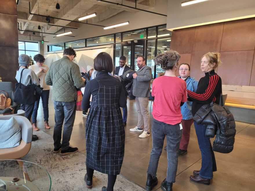 Ajamu Dillahunt-Holloway, Michael Palm, and several other professors stand awaiting to hand the AAUP petition to Hans on Dec 12, 2025. Hans never showed and instead sent a System Office representative.