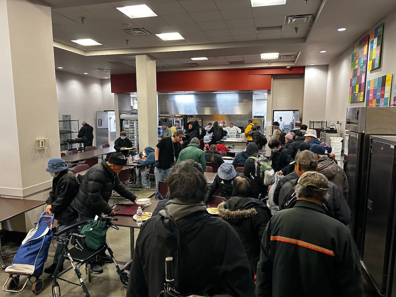 A group of people at a cafeteria.