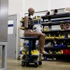 An assembled crash test dummy sits on a moveable desk in the assembly area at a Humanetics production facility in Huron, Ohio.