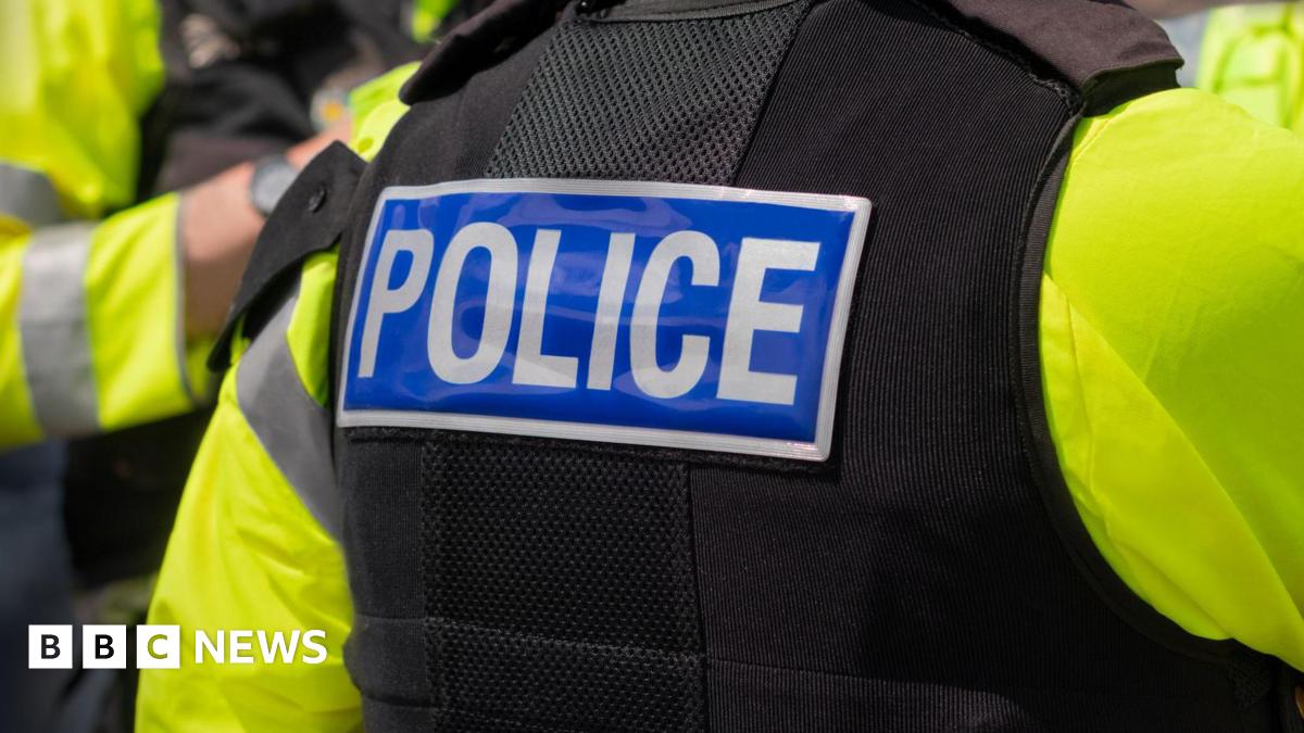 A stock image of the back of a police officer in uniform.