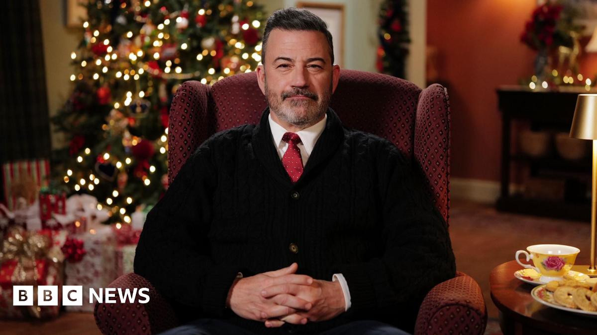 Jimmy Kimmel sitting in front of a Christmas tree as he delivers Channel 4's alternative Christmas message