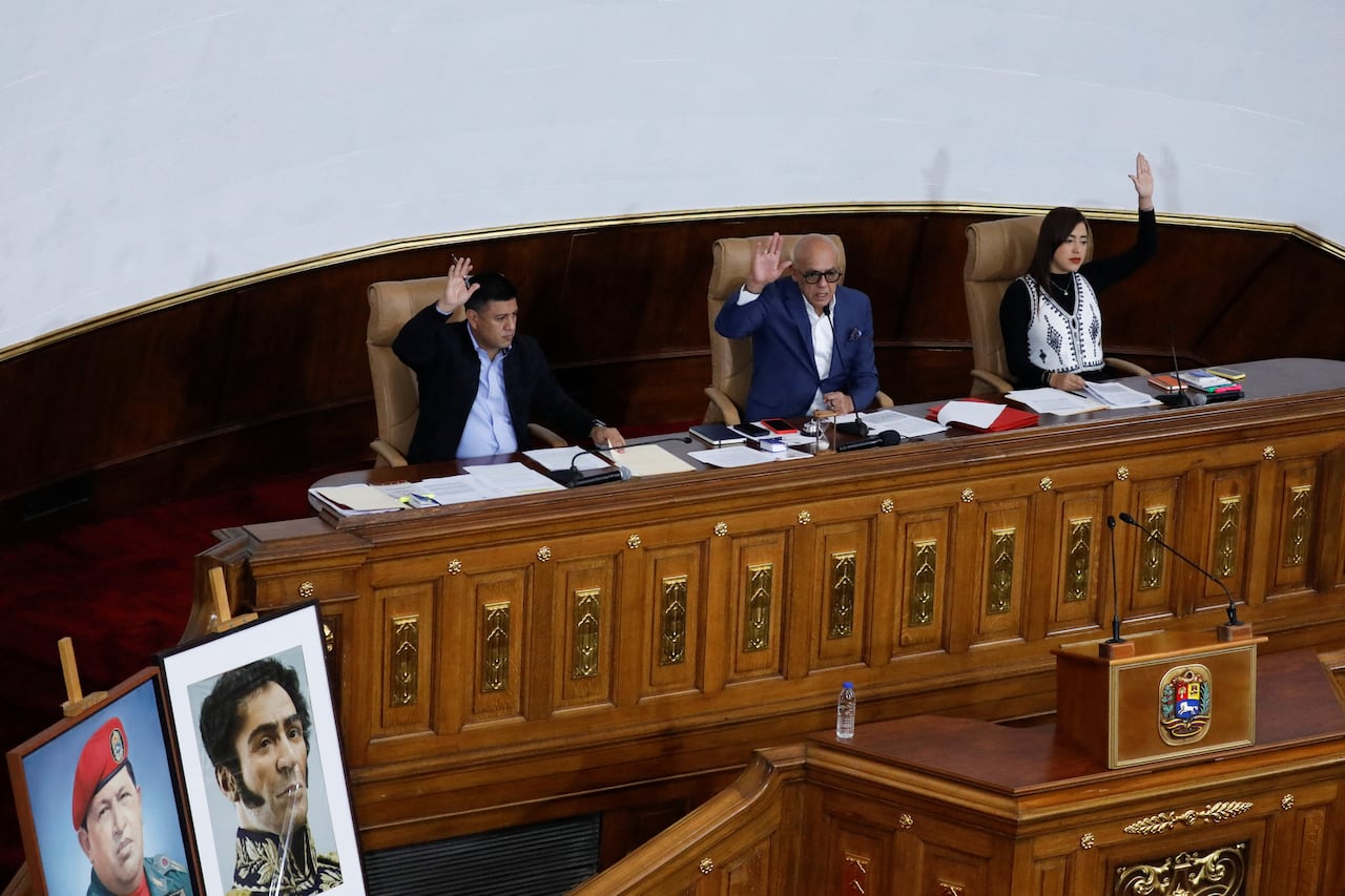 a legislature with people holding their hands up