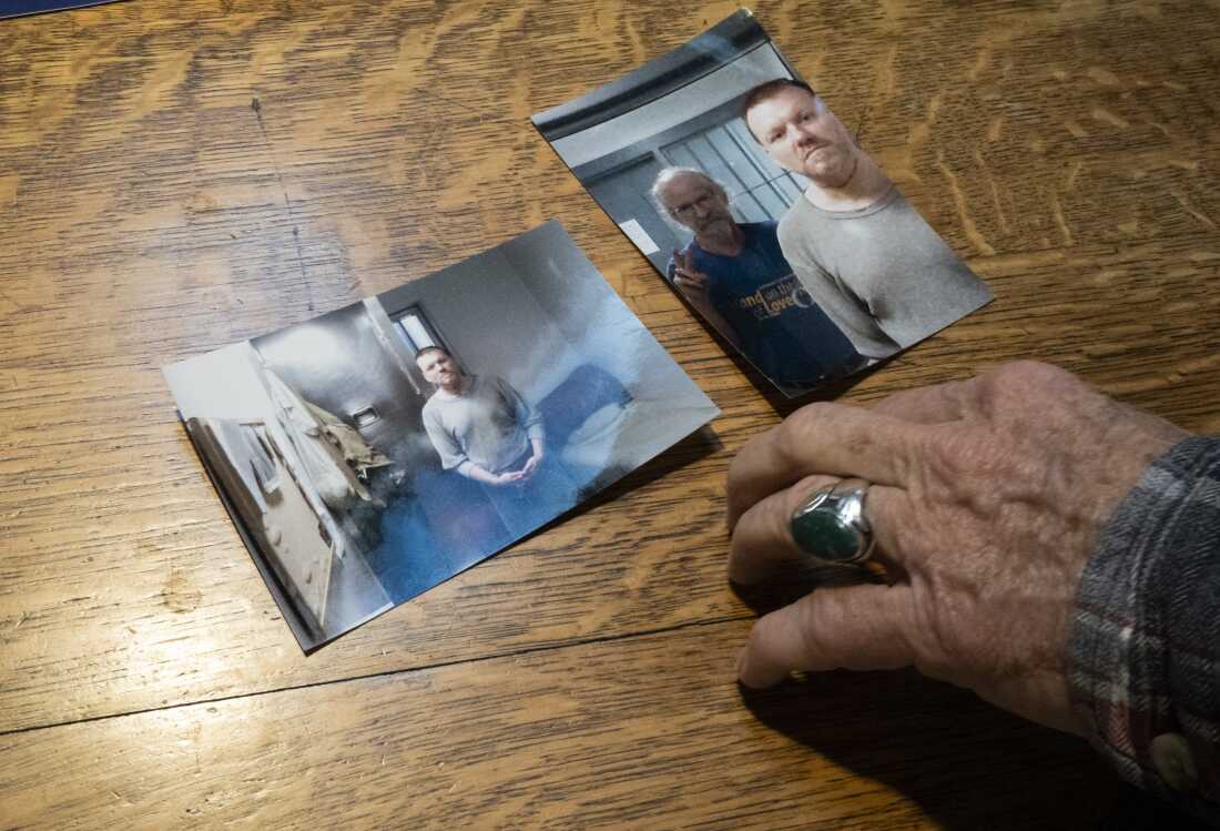 Bill Breeden displays the images of Chadrick “Chad” Fulks after meeting with him post-surgery related to Fulk’s suicide attempt in his cell, Wednesday, Dec. 17, 2025; Breeden’s home in Spencer, IN. USA; Wednesday, Dec. 17, 2025 Mandatory Credit: /NPR