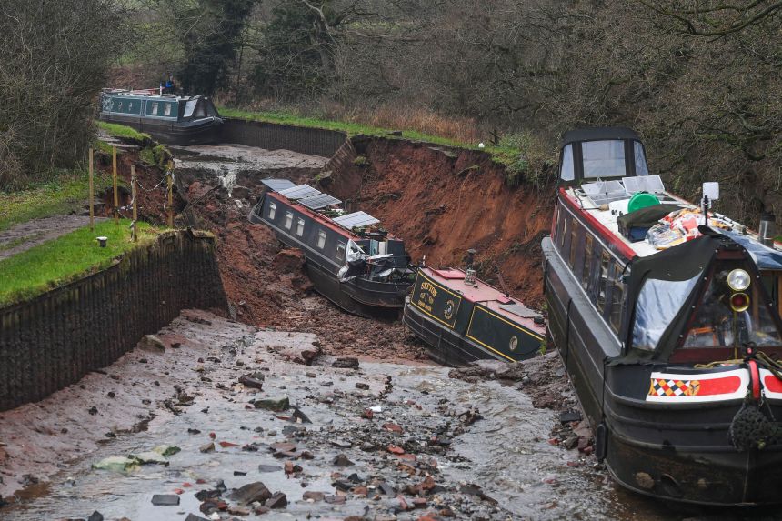 Canal boats lie damaged after a sinkhole developed in Shropshire, England, on December 22, 2025.