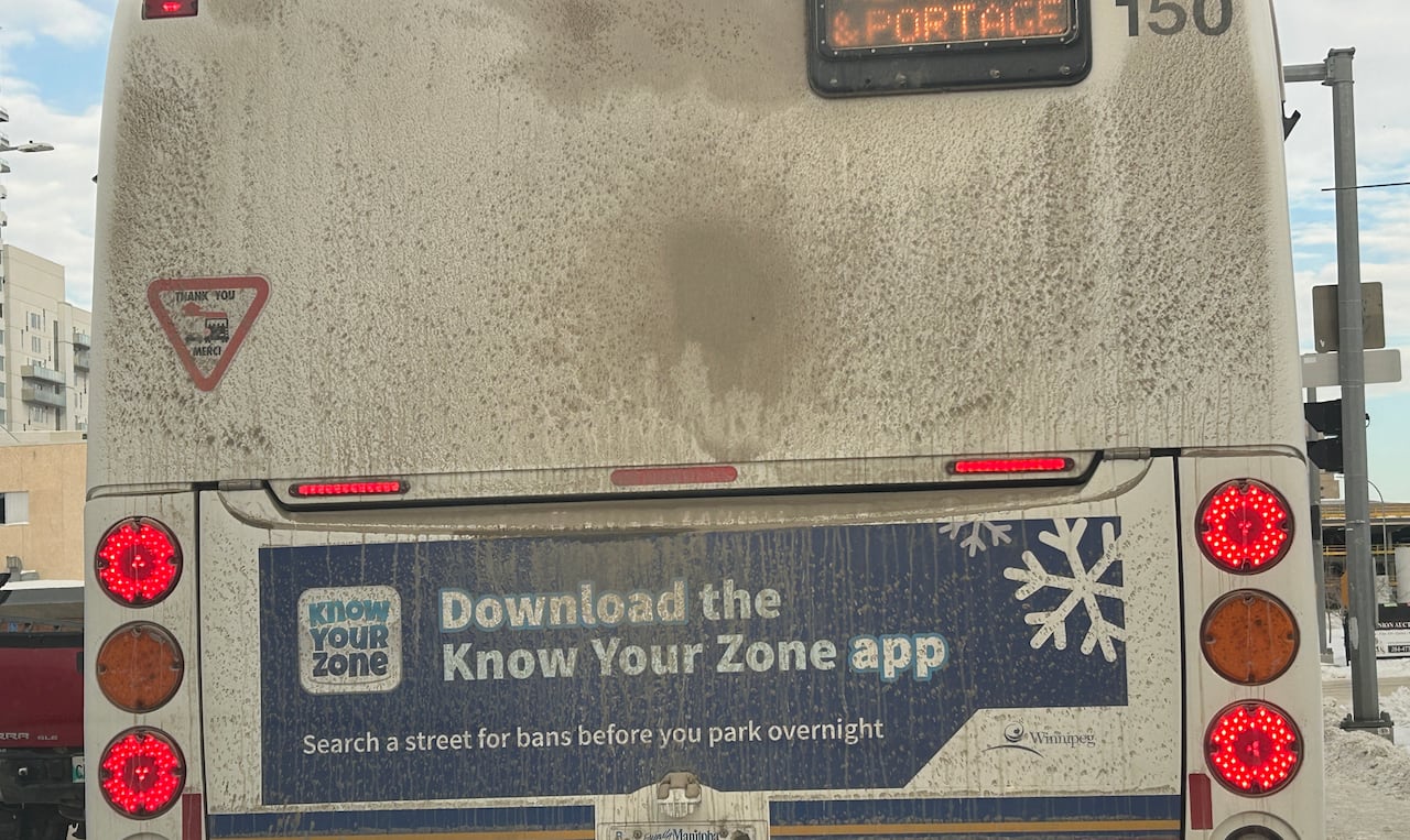 An advertisement on the back of a transit bus says "Download the Know Your Zone app. Search a street for bans before you park overnight."