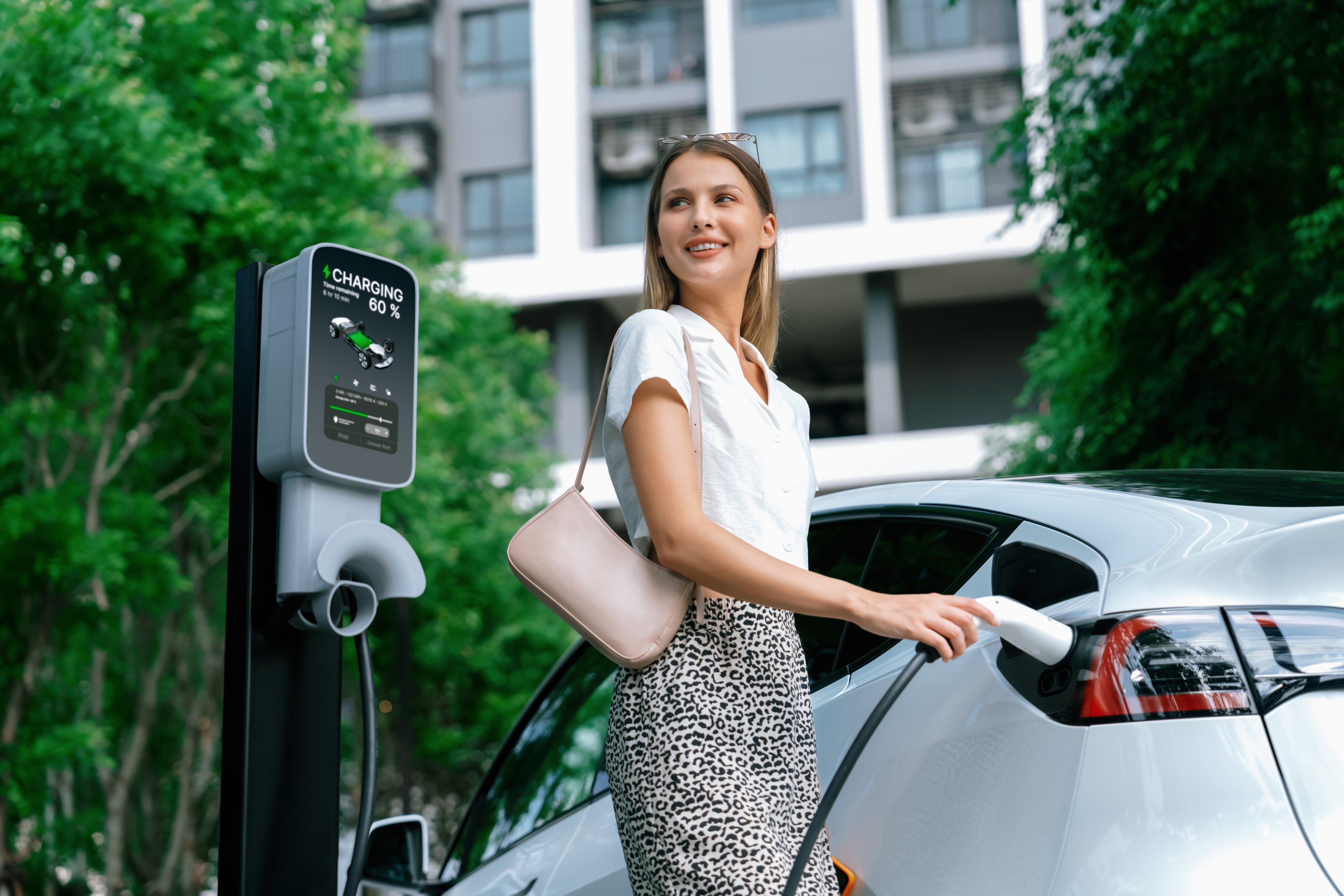 A woman charges her electric car.