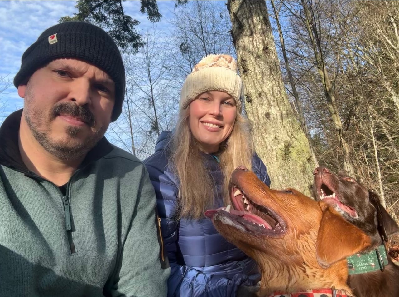 woman and man with two dogs