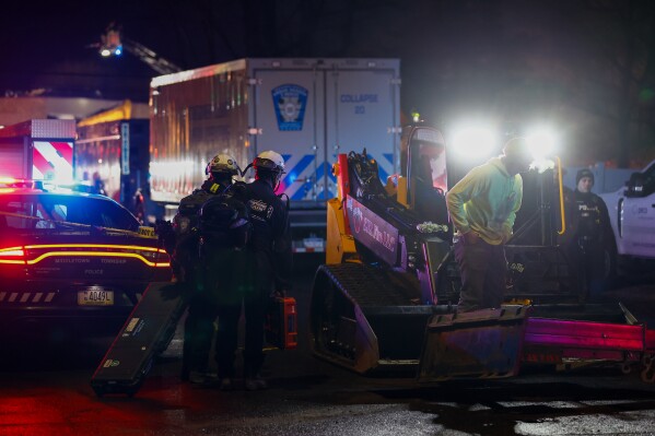Montgomery County search and rescue join first responders at the scene of an explosion and fire at Bristol Health & Rehab Center, Tuesday, Dec. 23, 2025, in Bristol Township, Pa. (Monica Herndon/The Philadelphia Inquirer via AP)