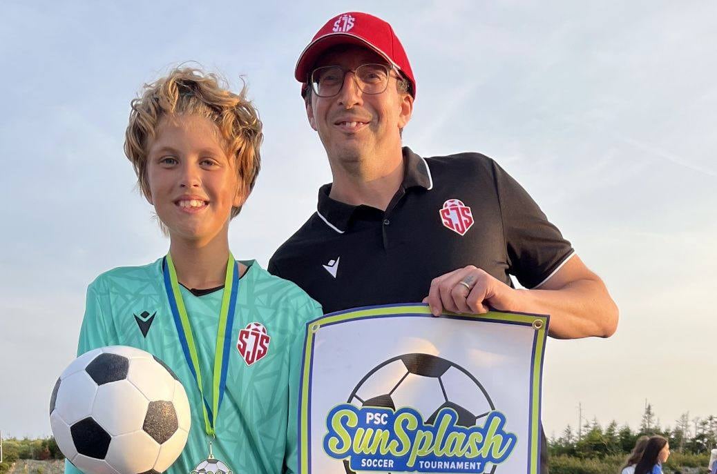 A boy and his father after winning a soccer tournament 