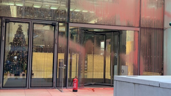 The scene at Aspen Insurance at Plantation Place in the City of London, after two activists sprayed red paint over the front of the building, in support of the Palestine Action protesters on hunger strike in prison, Tuesday, Dec. 23, 2025. (Shivansh Gupta/PA via AP)
