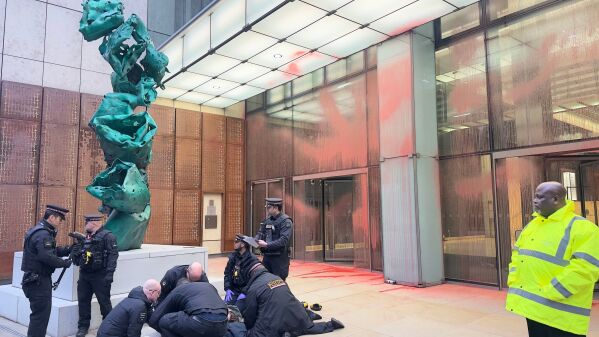 The scene at Aspen Insurance at Plantation Place in the City of London, after two activists sprayed red paint over the front of the building, in support of the Palestine Action protesters on hunger strike in prison, Tuesday, Dec. 23, 2025. (Shivansh Gupta/PA via AP)