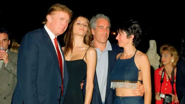 Younger Trump on di left, e wearsuit with red tie, next to Melania wey wear low-cut black dress wit spaghetti straps, her eyes dey closed and she lean her head toward Jeffrey Epstein, wey dey look out at di camera, e wear polo shirt and blazer and e put im arm around di waist of Ghislaine Maxwell, wey dey look toward di group and wey wear short denim halter top wit beaded fringe