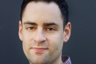 The Australian Jewish Association CEO Robert Gregory is standing in front of a wall