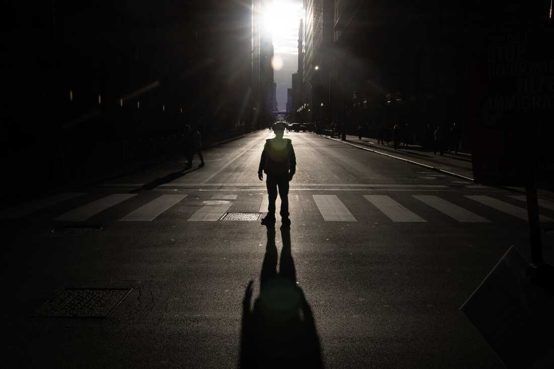 A police officer stands guard as demonstrators marched through downtown Chicago this fall, protesting President Trump's show of federal force aimed at immigration enforcement in the city. Trump called Chicago the “most dangerous city in the world,” though crime has fallen there in recent years.