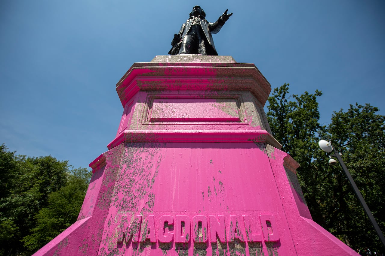 Demonstrators threw pink paint on a statue of Sir. John A. Macdonald at Queen's Park in Toronto on Saturday, July 18, 2020.