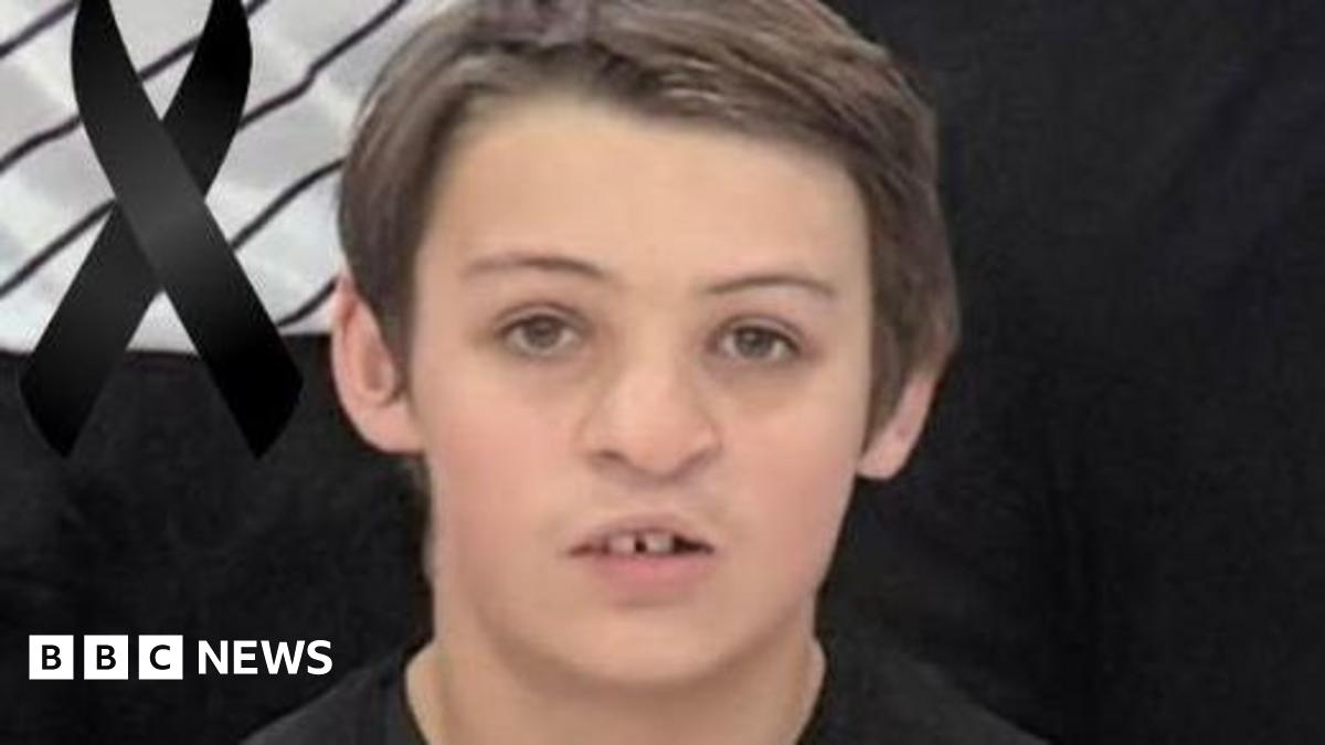 An image of Alfie Hallett who is wearing a black basketball uniform and is looking directly at the camera