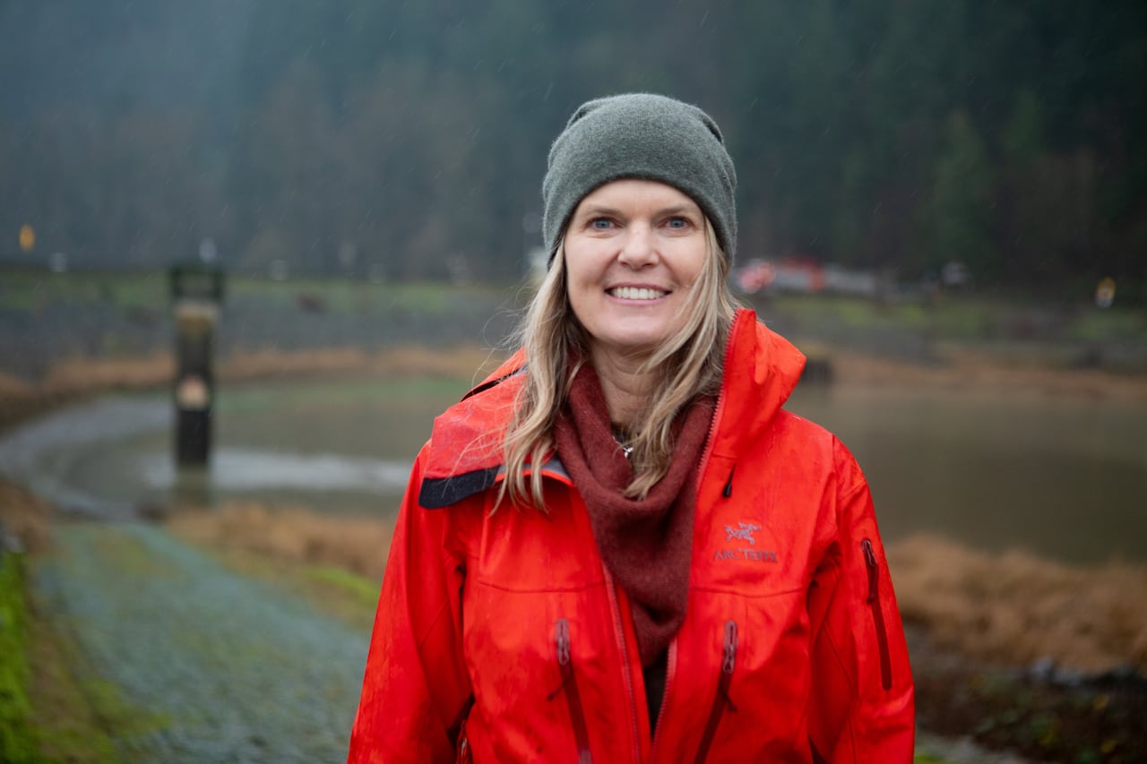 A woman stands in the Sumas Prairie. 