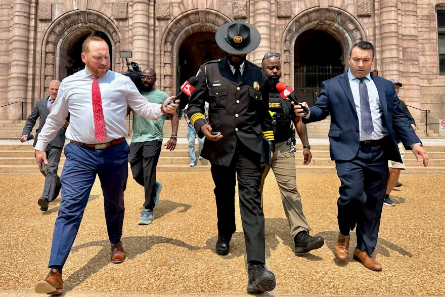 St. Louis Sheriff Alfred Montgomery remains silent as media barrage him with questions after leaving a heated Board of Alderman budget hearing on Monday, June 2, 2025, at City Hall in downtown St. Louis.