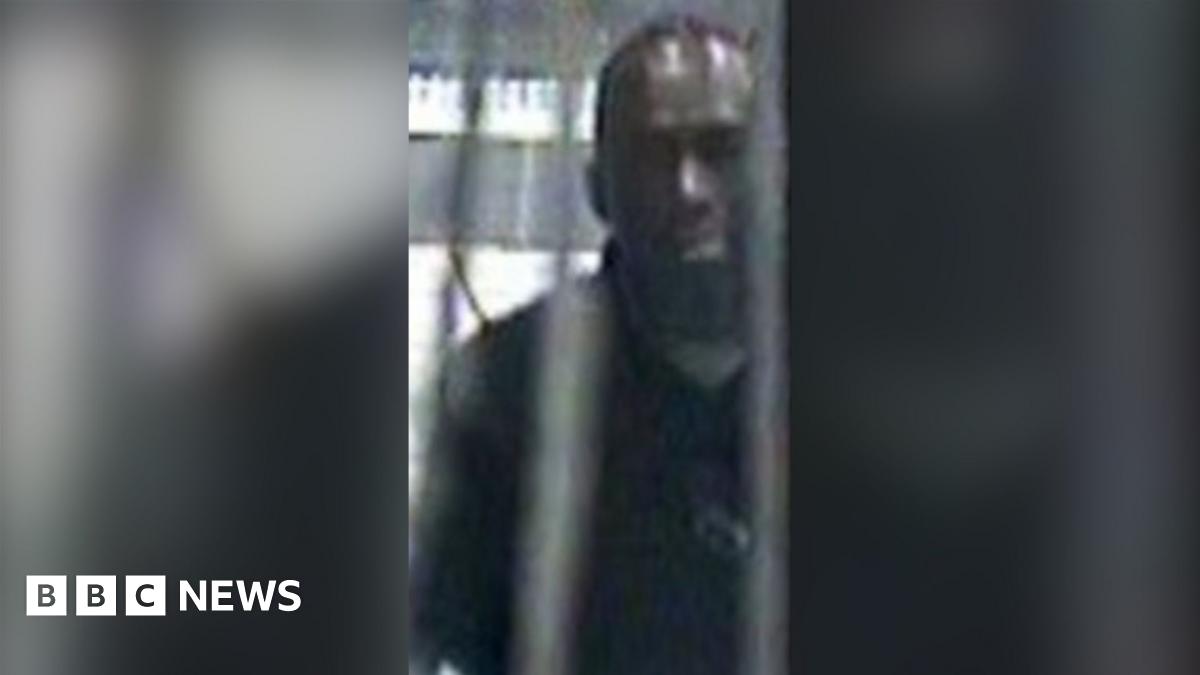 A grainy CCTV image of a man in a Tube station.