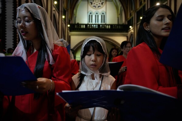 Christians attend prayer on Christmas Eve, Wednesday, Dec. 24, 2025, at St. Mary Cathedral in Yangon, Myanmar. (AP Photo/Thein Zaw)