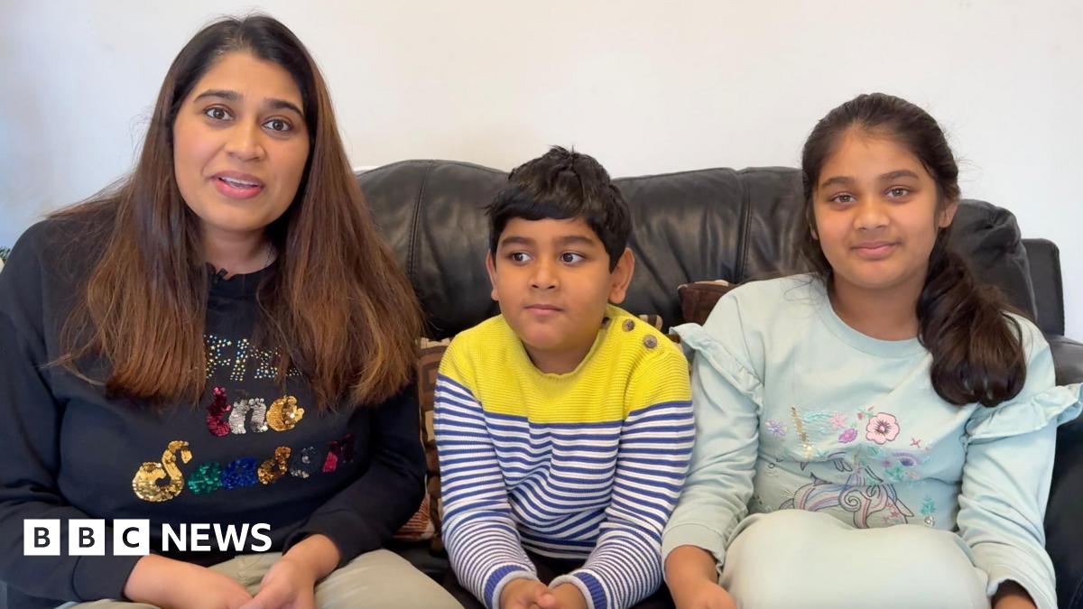 Pooja (left) and her son (middle) and daughter (right) on the sofa.