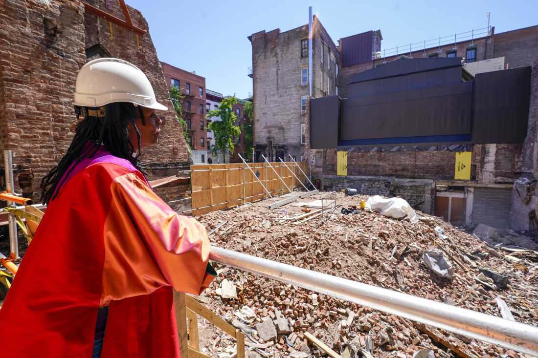 Senior Pastor Rev. Jacqueline J. Lewis poses overlooking the rubble of Middle Collegiate Church in New York’s East Village on June 16, 2021, after the historic building was destroyed by a six-alarm fire in December 2020. Lewis recently spoke with NPR’s Morning Edition about marking Christmas this year with the church’s first in-person Christmas Eve service since the fire,