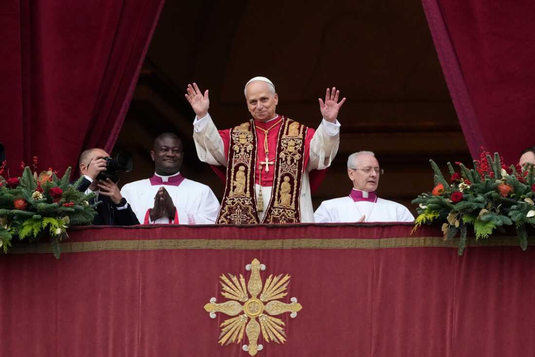 Pope Leo XIV waves Thursday after delivering the Urbi et Orbi (Latin for 'to the city and to the world' ) Christmas blessing from the main balcony of St. Peter's Basilica at the Vatican.