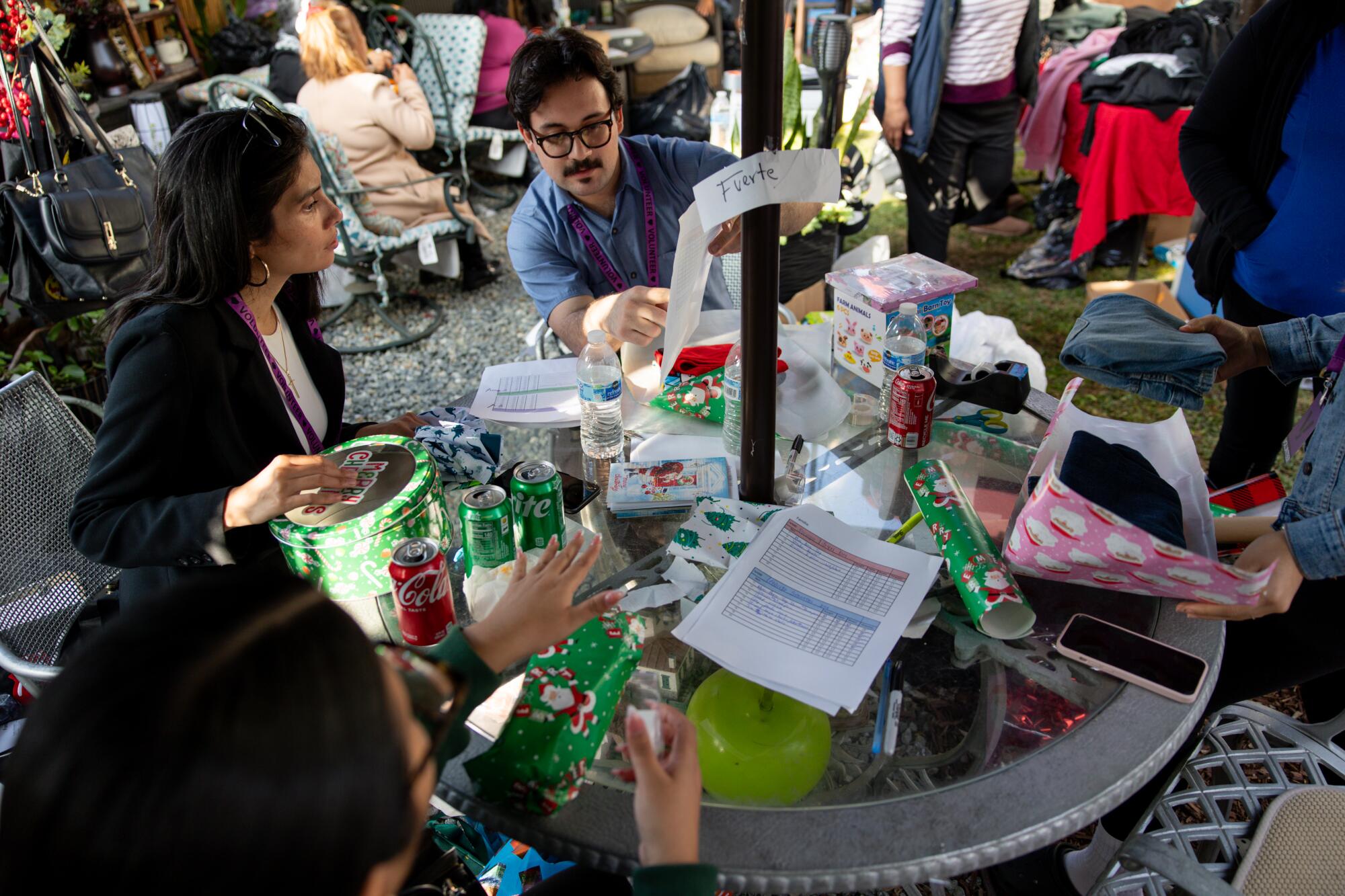 Volunteers put together a gift bag for an immigrant family during an angel tree event in Maywood.