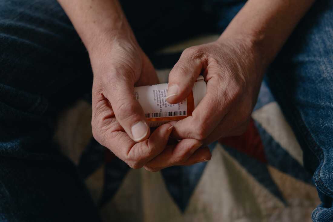 Brooklyn freelancer Brad Lawrence, 54, holds his prescription medication for kidney disease. He and his wife face more out-of-pocket costs in 2026, after enhanced subsidies expired on their Affordable Care Act plan.