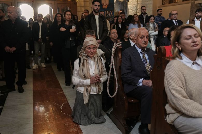 People attend the Christmas morning Mass at Church of the Nativity on Thursday.