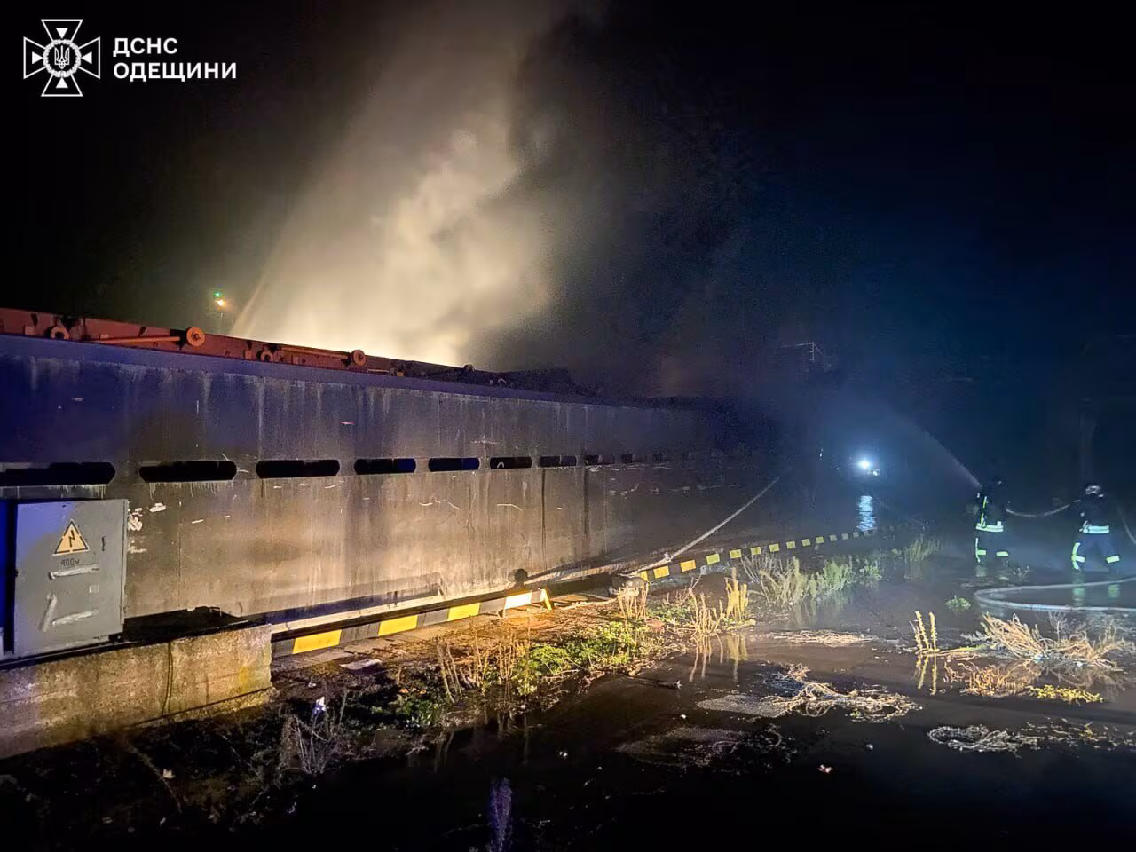 A vessel is on fire in a harbour