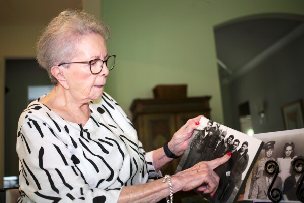 June West Brandt, 93, holds a photo displaying her brother, William Durham West Jr., who was killed in World War II, Aug. 27, 2025, in Richmond, Texas. (AP Photo/Lekan Oyekanmi)