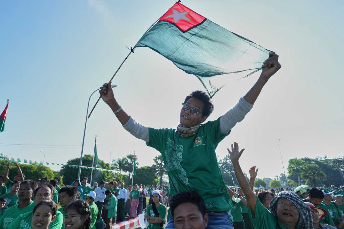 Supporters of the military-backed Union Solidarity and Development Party wave the party flags during the first day of campaigning for the general election, in Naypyitaw, Myanmar, Oct. 28.