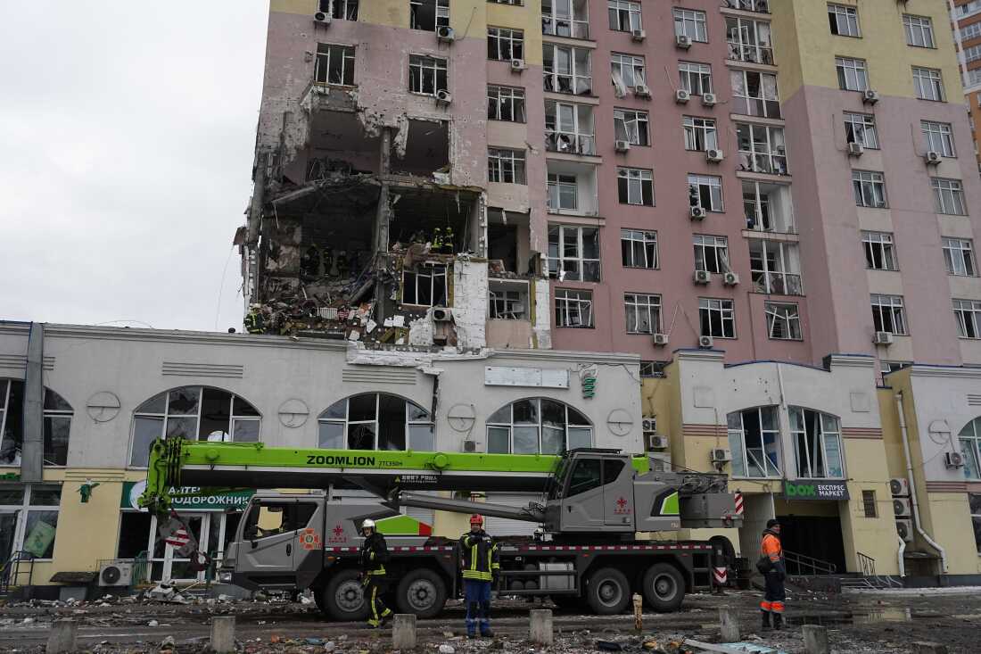 Rescuers work on the scene of a building damaged by a Russian attack in Kyiv, Ukraine, Saturday, Dec. 27, 2025.