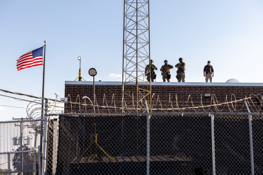 Snipers survey the perimeter from the roof outside the Broadview federal immigration processing center in September.