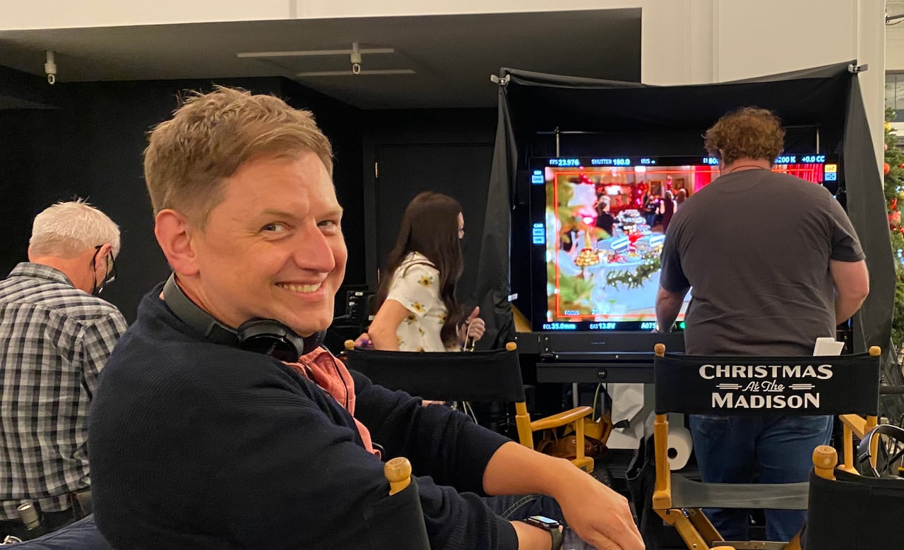 A man sits in a directors chair