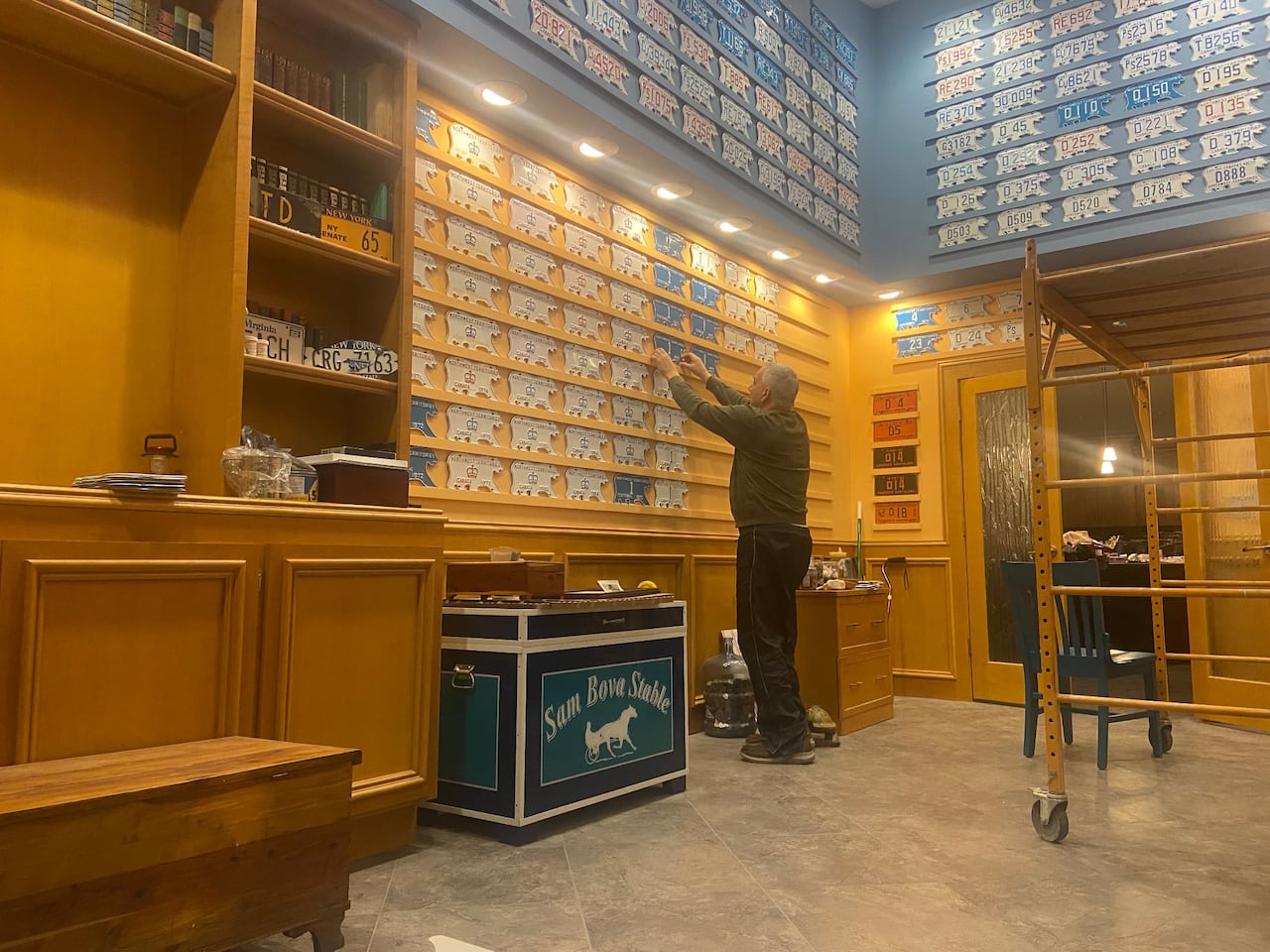 A man working on his polar bear licence plate collection.