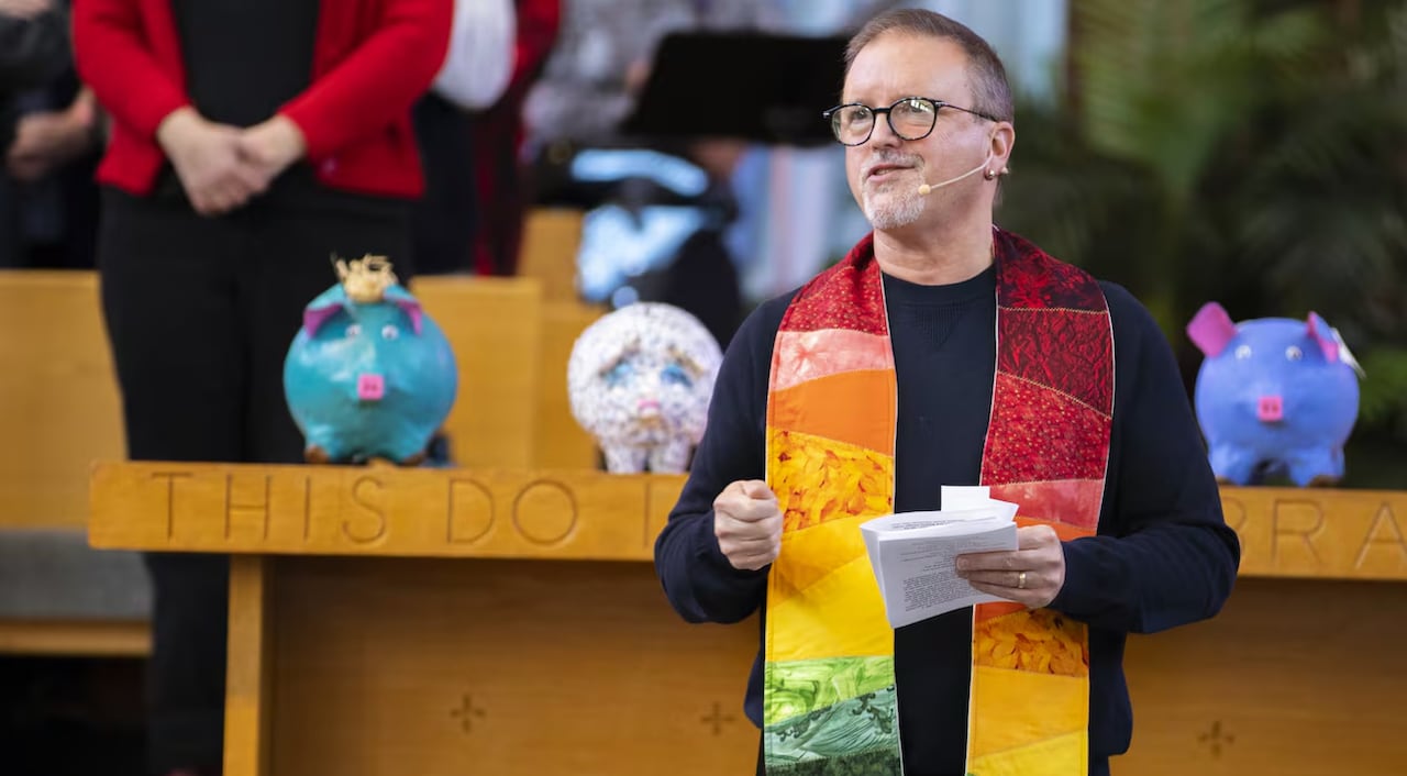 A reverend speaks at the pulpit.