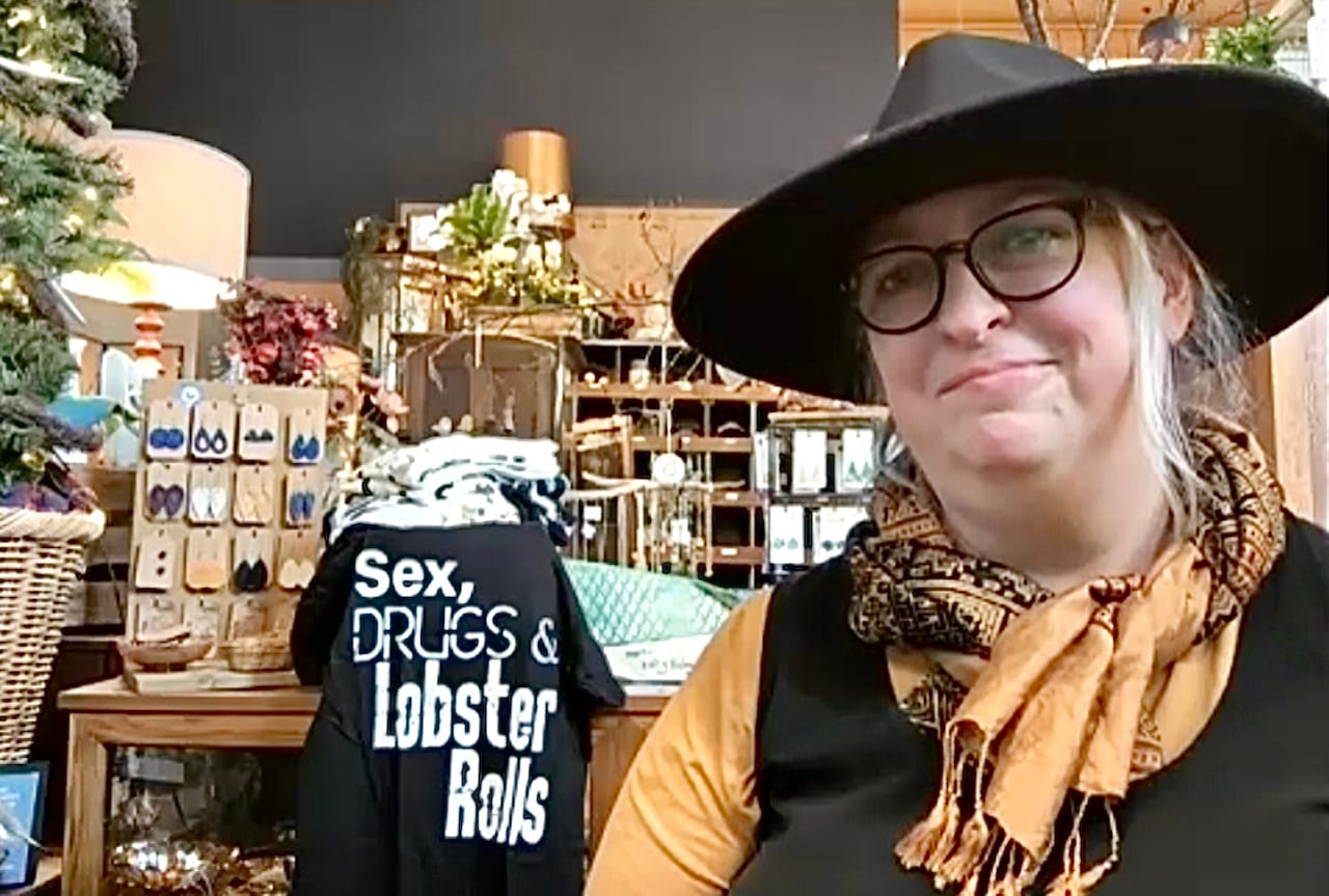 A woman with a homewares store in the background.