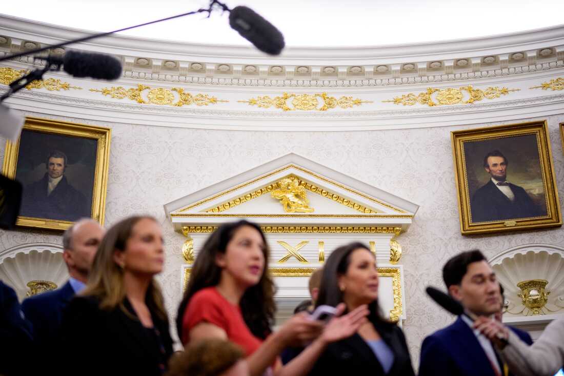Paintings and gold trim are visible behind reporters as U.S. President Donald Trump holds a swearing in ceremony.