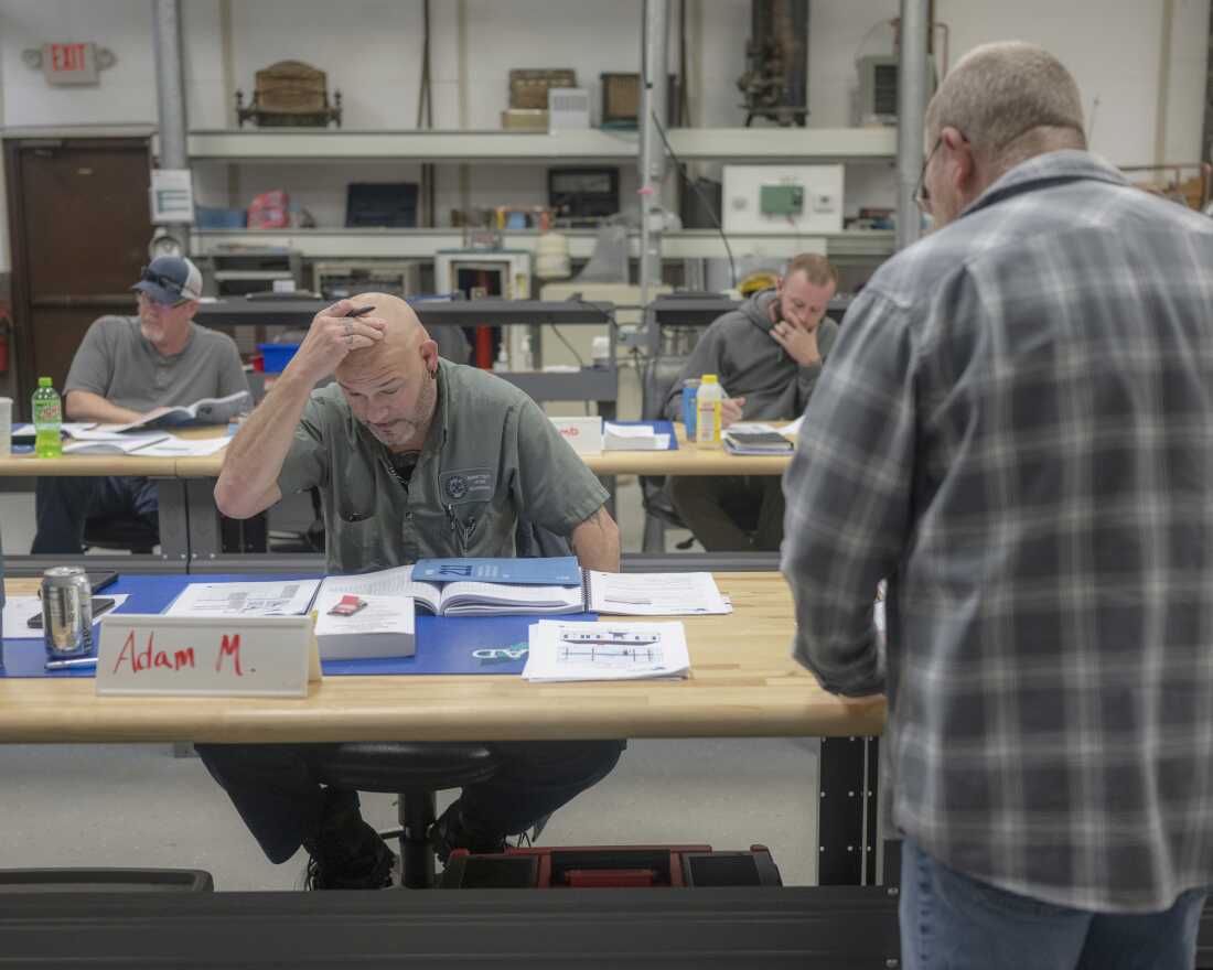 Adam Murdock, left, attends attends a training class for weatherization inspectors at Corporation Ohio Appalachian Development's Weatherization Training Center as training coordinator Dave Freeman, right, gives instruction, on Dec. 9, in Athens, Ohio. COAD is a non-profit that provides essential services like weatherization, energy assistance, childcare resources, senior programs and workforce development. 