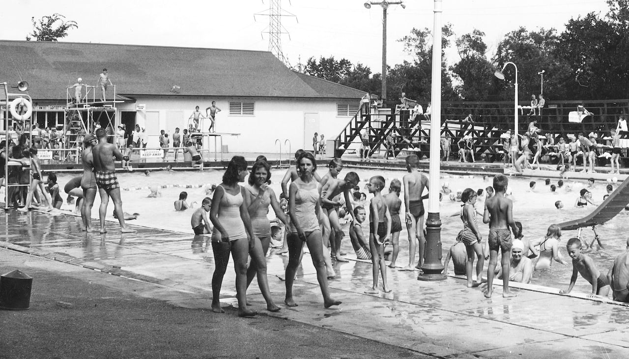 A black-and-white photo showing an outdoor pool in summer