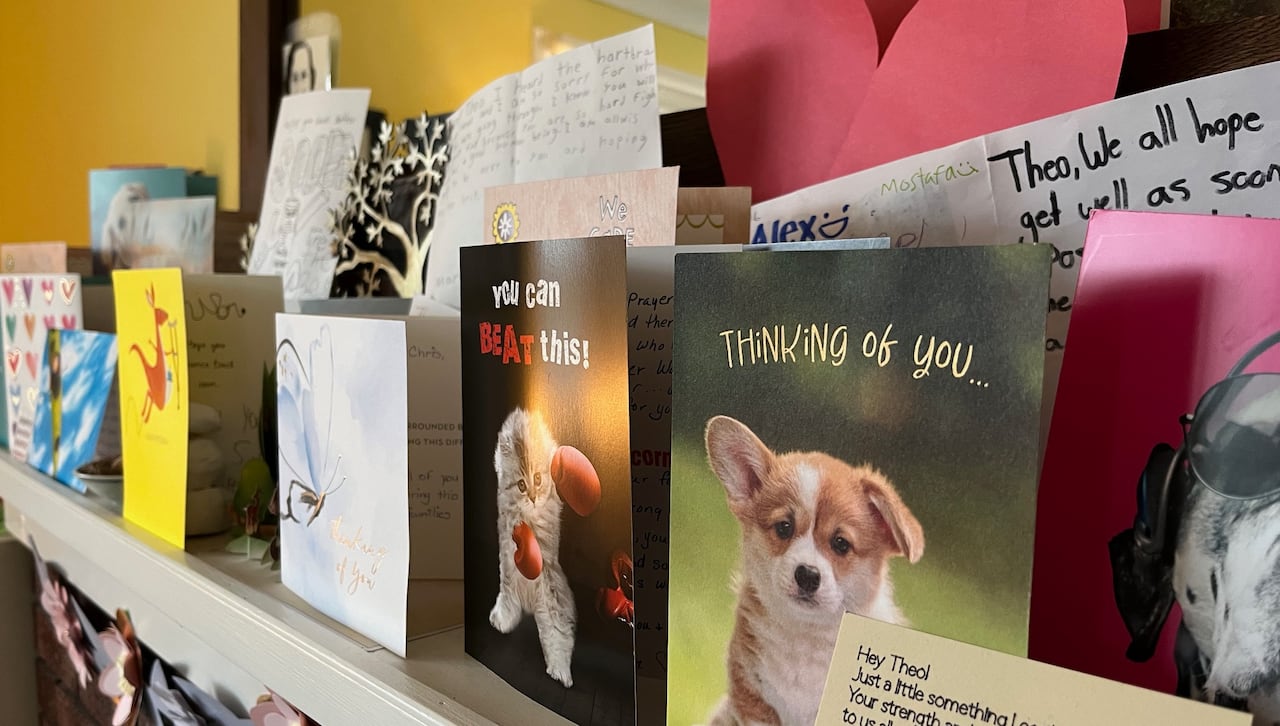 Dozens of "get well soon" cards line the top of a mantle.